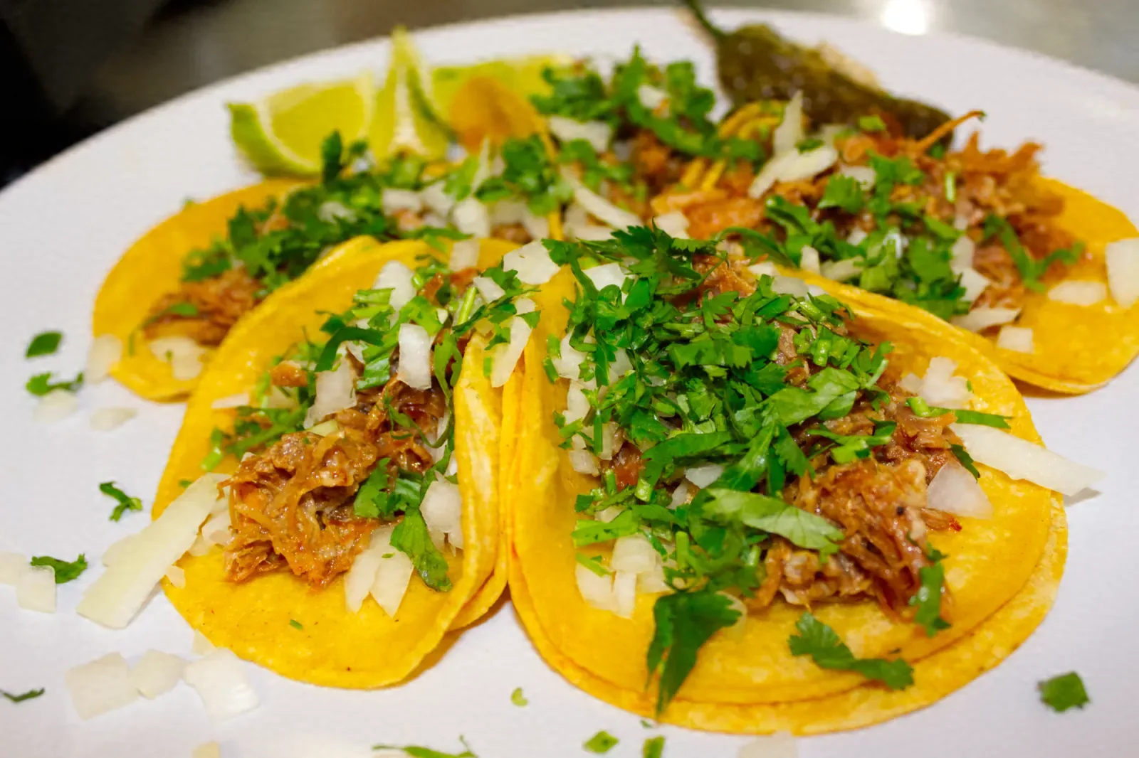 Tacos topped with cilantro and lime