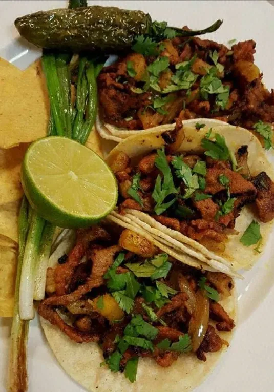 Tacos with grilled green onion and lime
